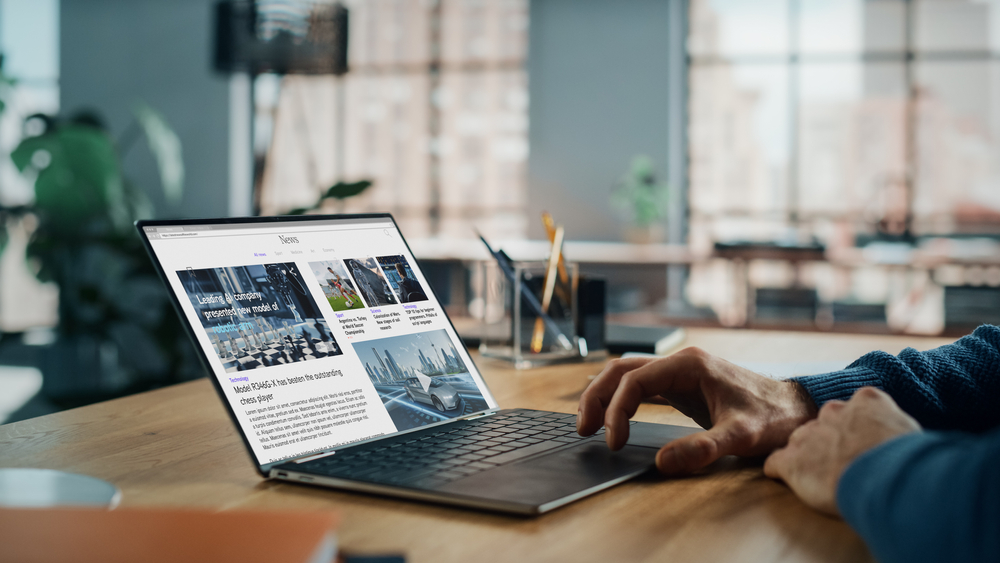 Computer on desk with news site open