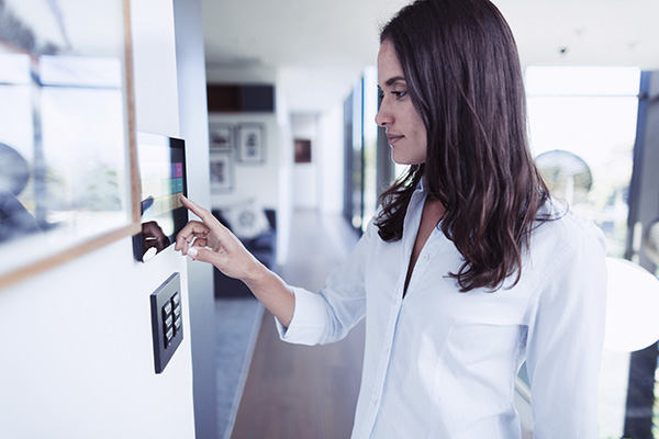 Woman in her house interacting with smart home technology