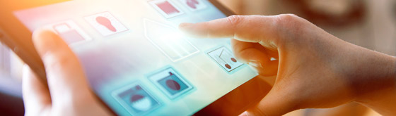 Smart Technology Tablet User using smart home technology in a connected tablet