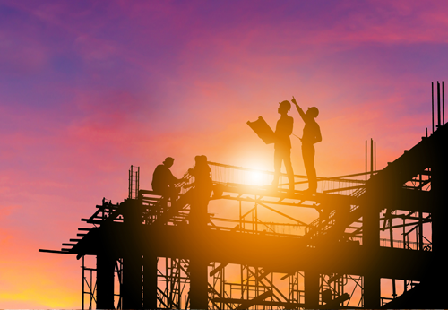 construction_skyscraper_sunset a group of people working on a structure