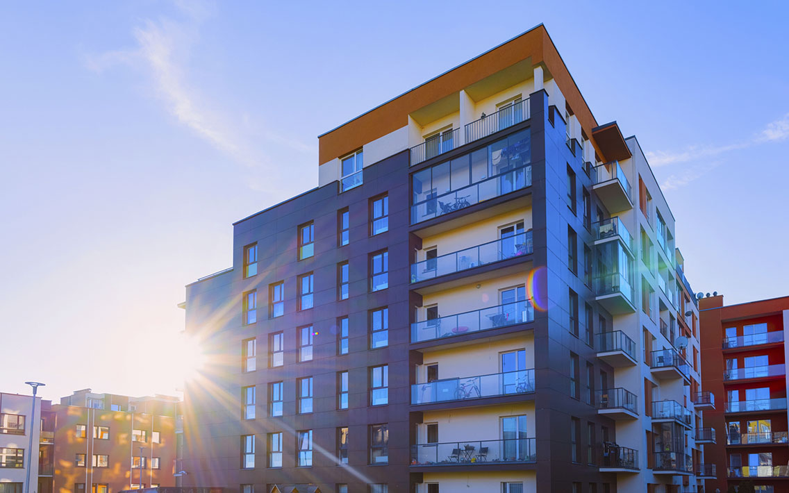 Side view of apartment complex at sunrise