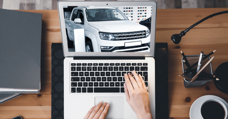 image of hands using laptop looking at an image of a car