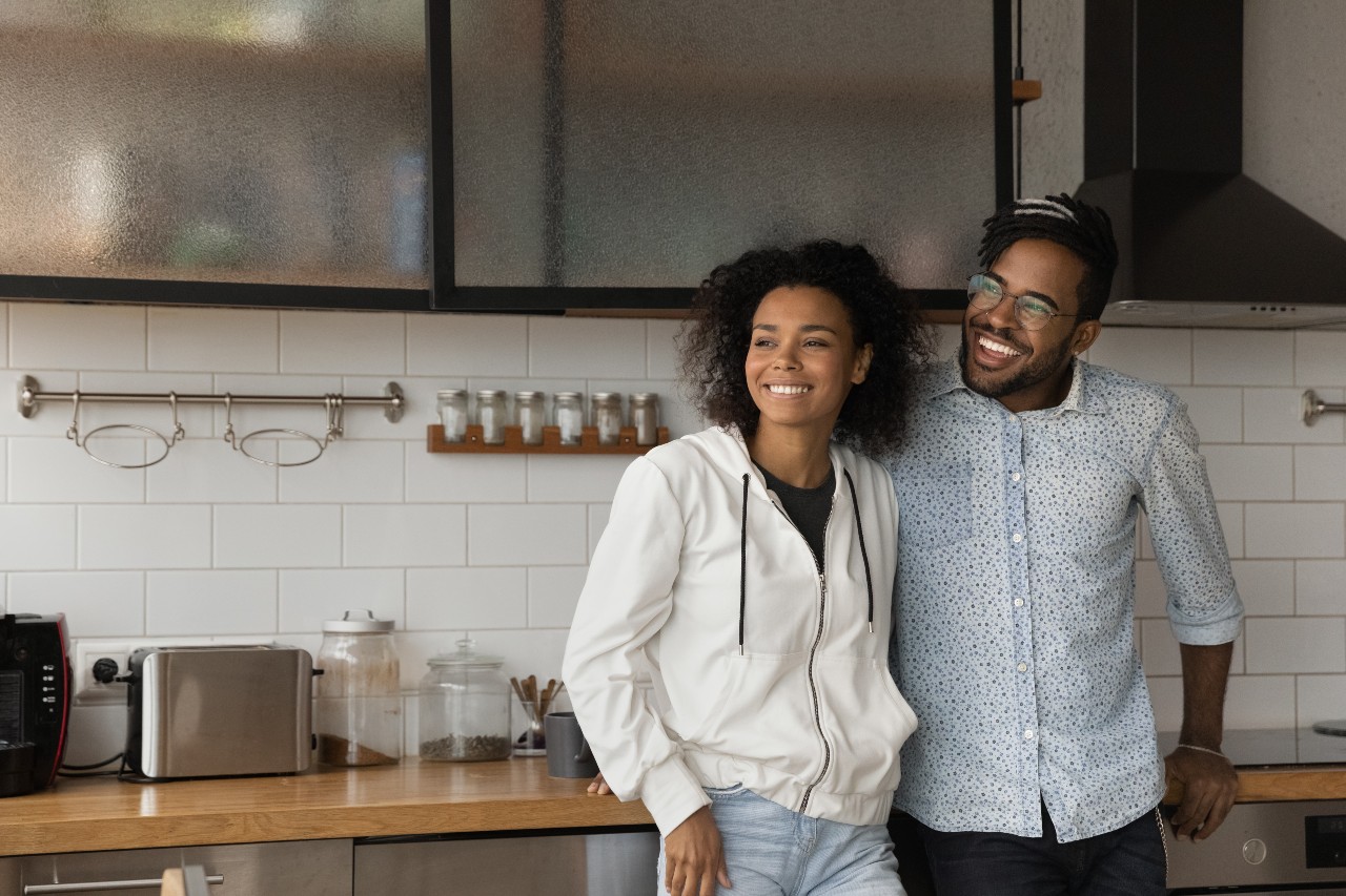 a man and a woman standing in a kitchen