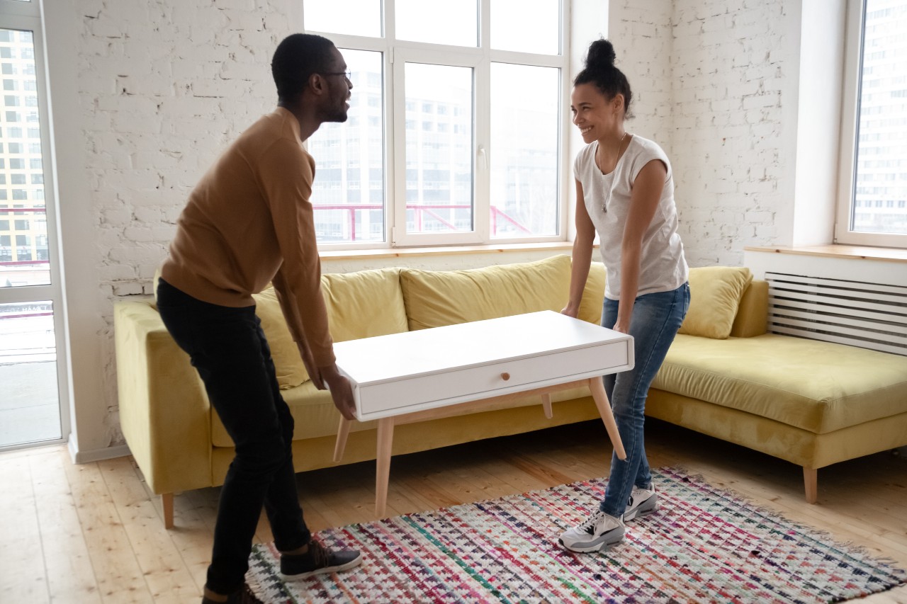 a man and a woman playing a piano in a room