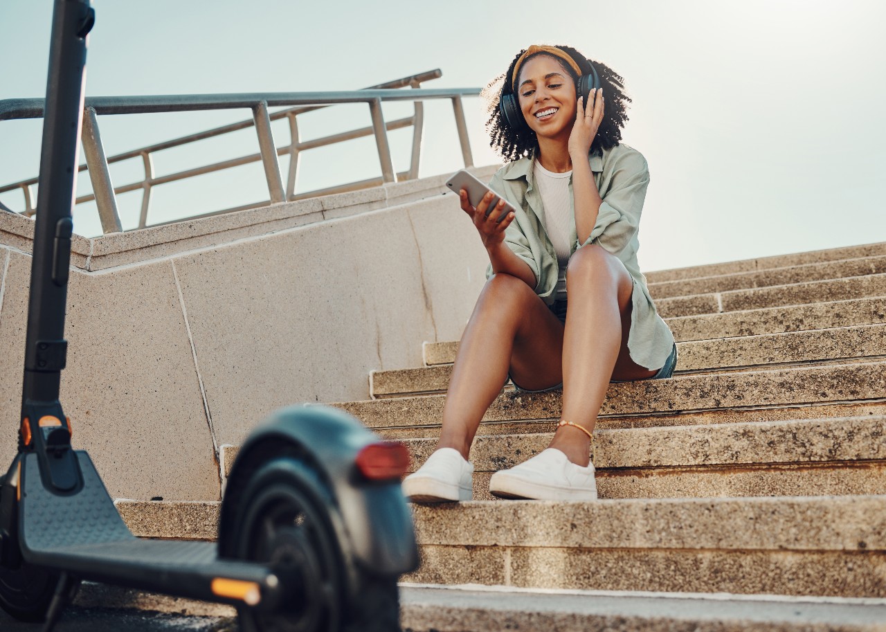 a person sitting on a set of stairs with a wheel chair and a steering wheel